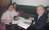 Song Weiming (left) and David Snipp sign contract